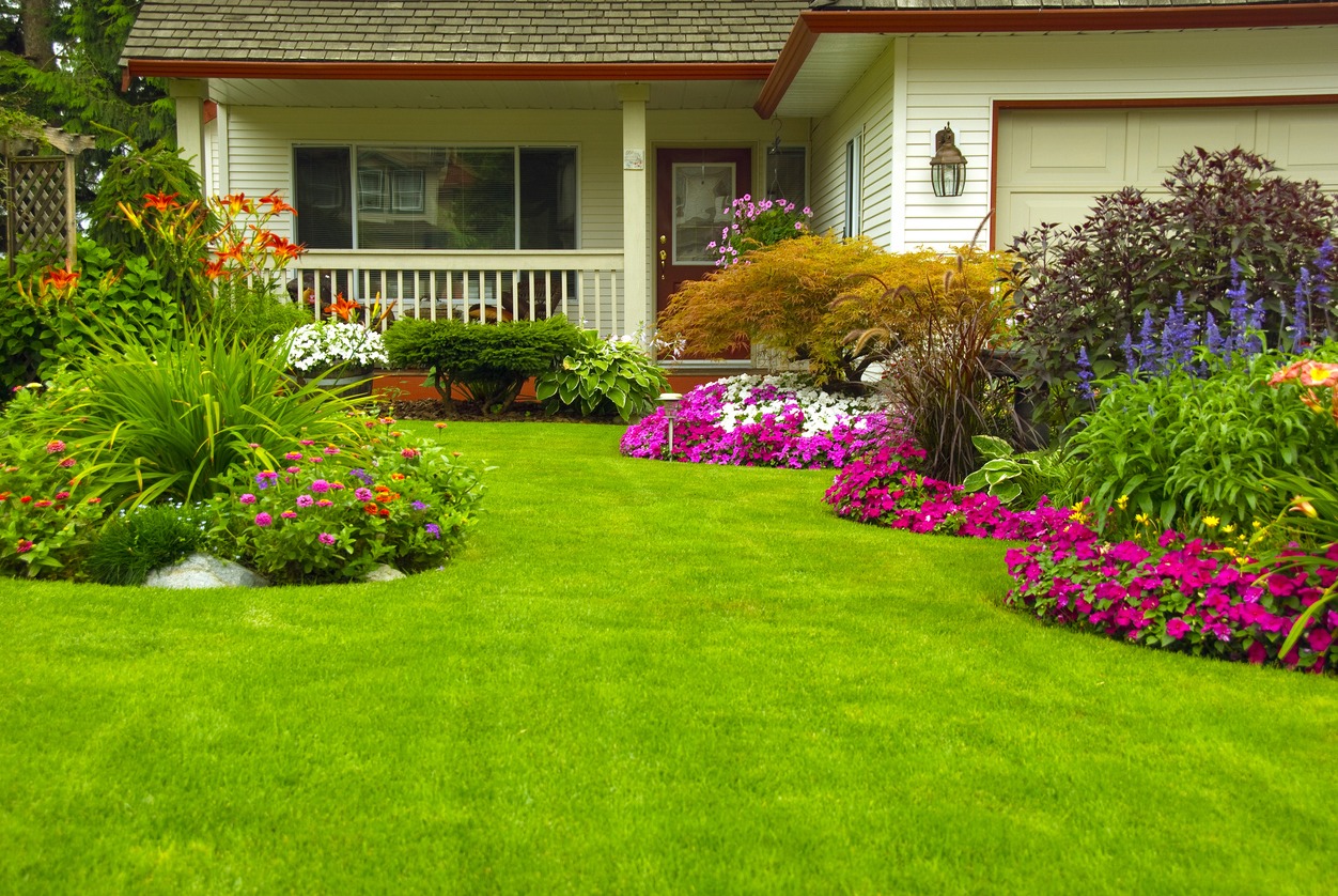 Colorful flower garden and manicured lawn in front yard