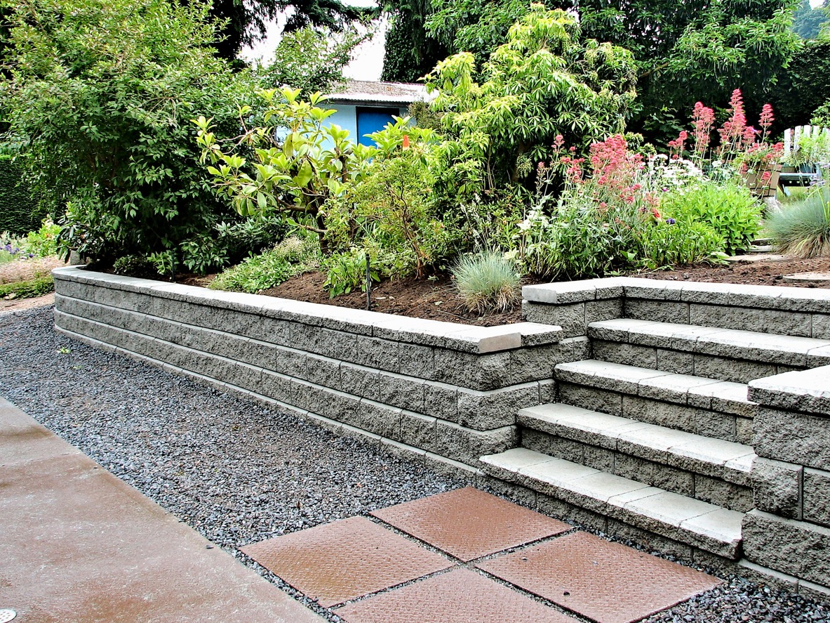 Stone retaining wall with garden and steps