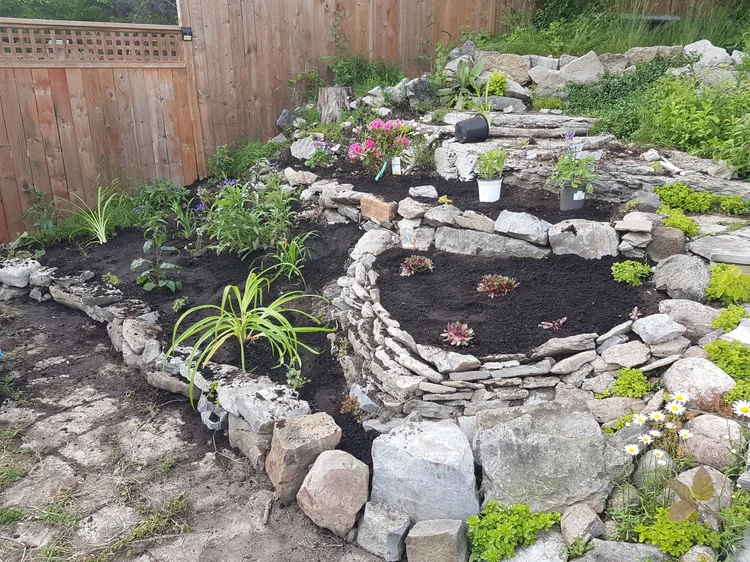 Tiered stone garden bed with fresh plants
