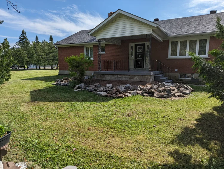 Single-story brick house with front porch and lawn