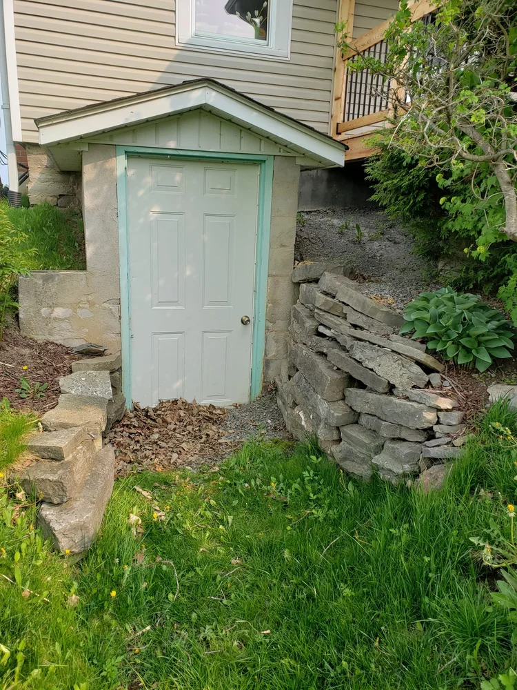 Small basement door built into hillside