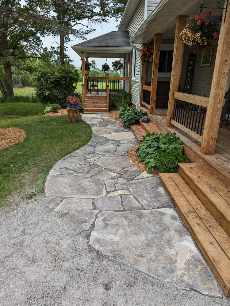Stone walkway leading to wooden front porch