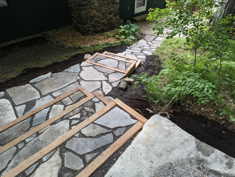 Stone walkway under construction with wooden framing