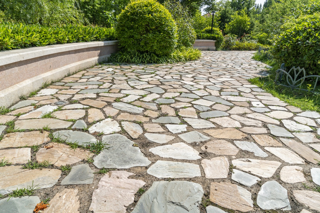 Stone garden pathway surrounded by lush greenery
