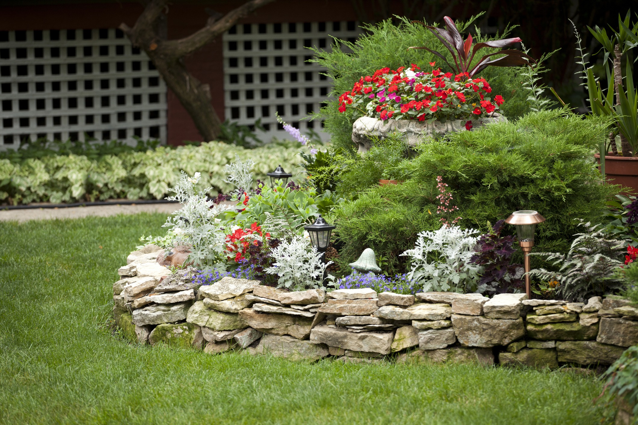 Colorful flower bed with stone border and lanterns